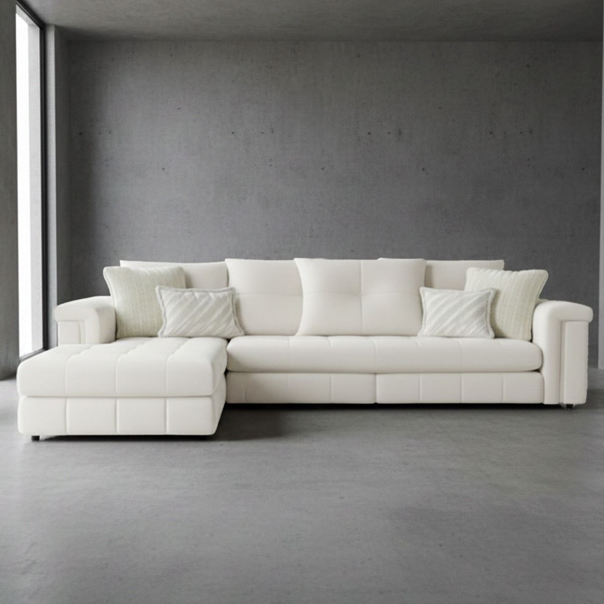 Modern cream L-shaped sectional sofa with right-hand chaise configuration and wide track arms against a grey wall.