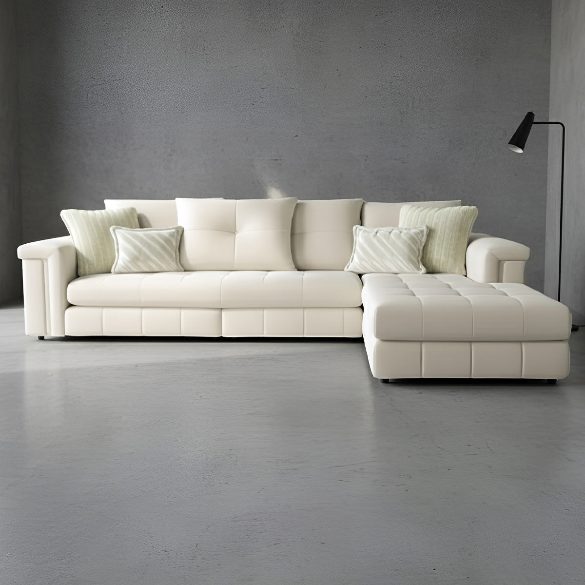 Contemporary cream sectional sofa with chaise lounge, featuring wide armrests and adjustable headrest mechanism.