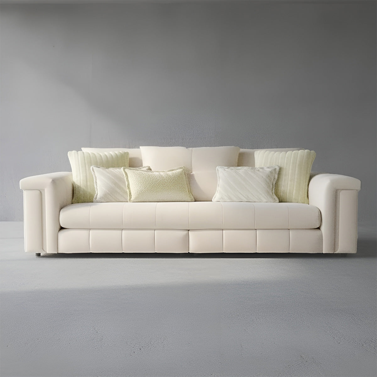 Front view of Alcotta 3-seater cream sofa featuring deep tufted seating and minimalist modern design.
