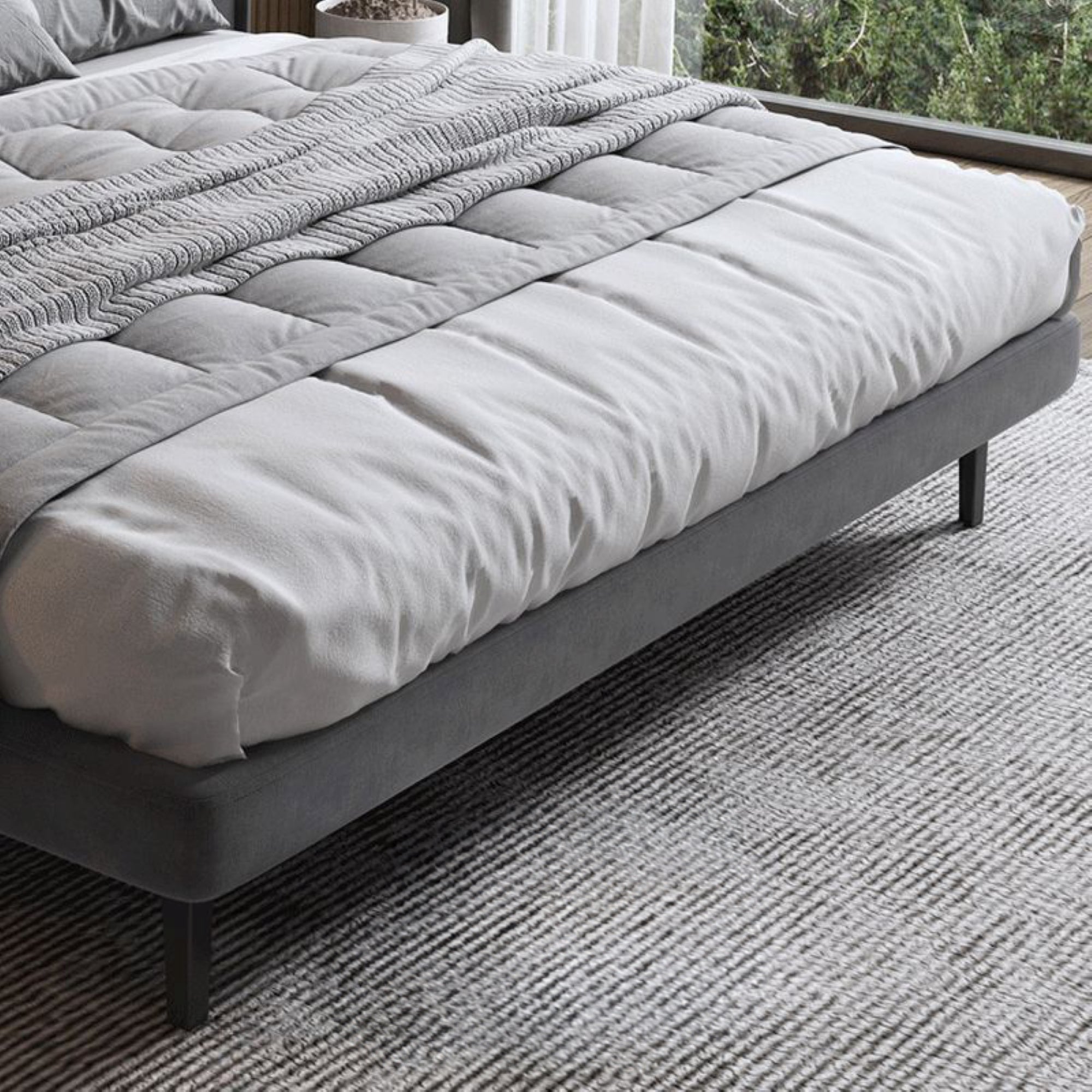 King size bed bed featuring sleek high legs and a modern style bed design.