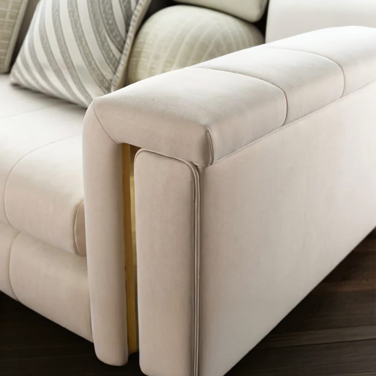 Detail view of Alcotta sofa wide armrest featuring a luxurious vertical gold metal insert and plush upholstery.