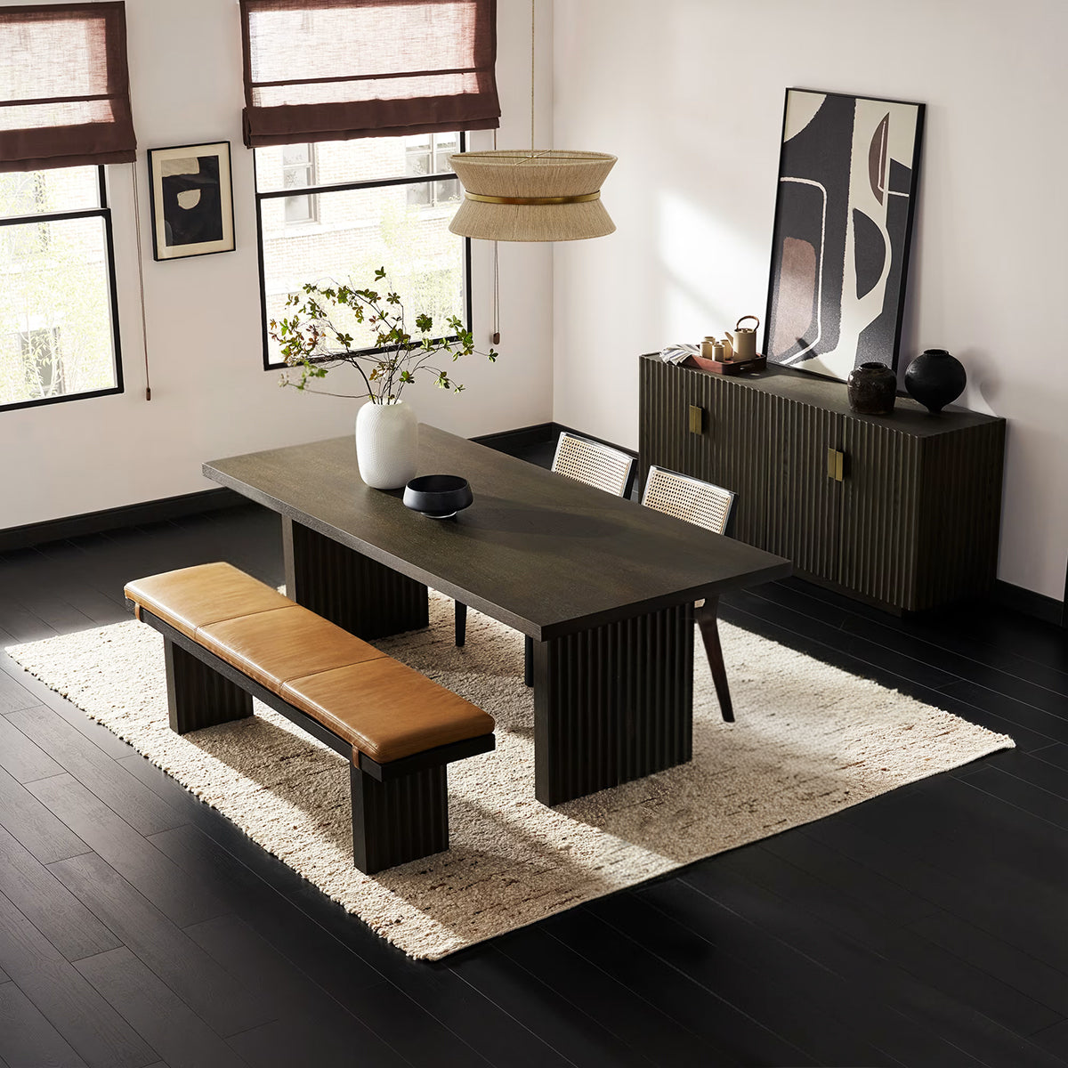 Reede Fluted Dark Wood Dining Table setup as a 4-seater with two cane back chairs and a leather bench.