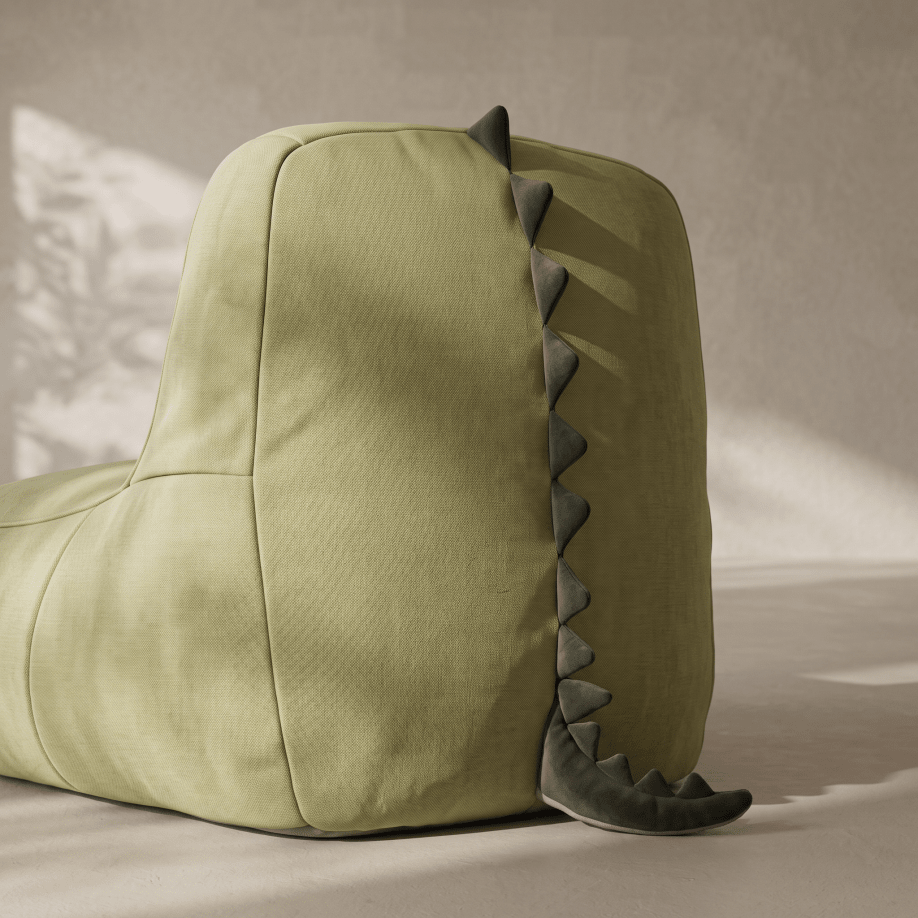 An olive green dinosaur-shaped bean bag chair with a dark gray faux-skin and spiky back detail, photographed in a styled studio setting with soft shadows.