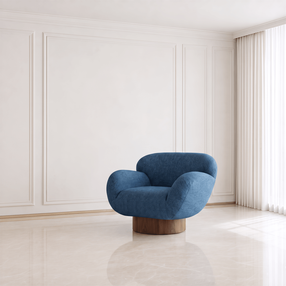 A modern blue upholstered accent chair with a curved, rounded silhouette and a wooden swivel base, set in a minimalist room with cream paneled walls and a light marble floor.