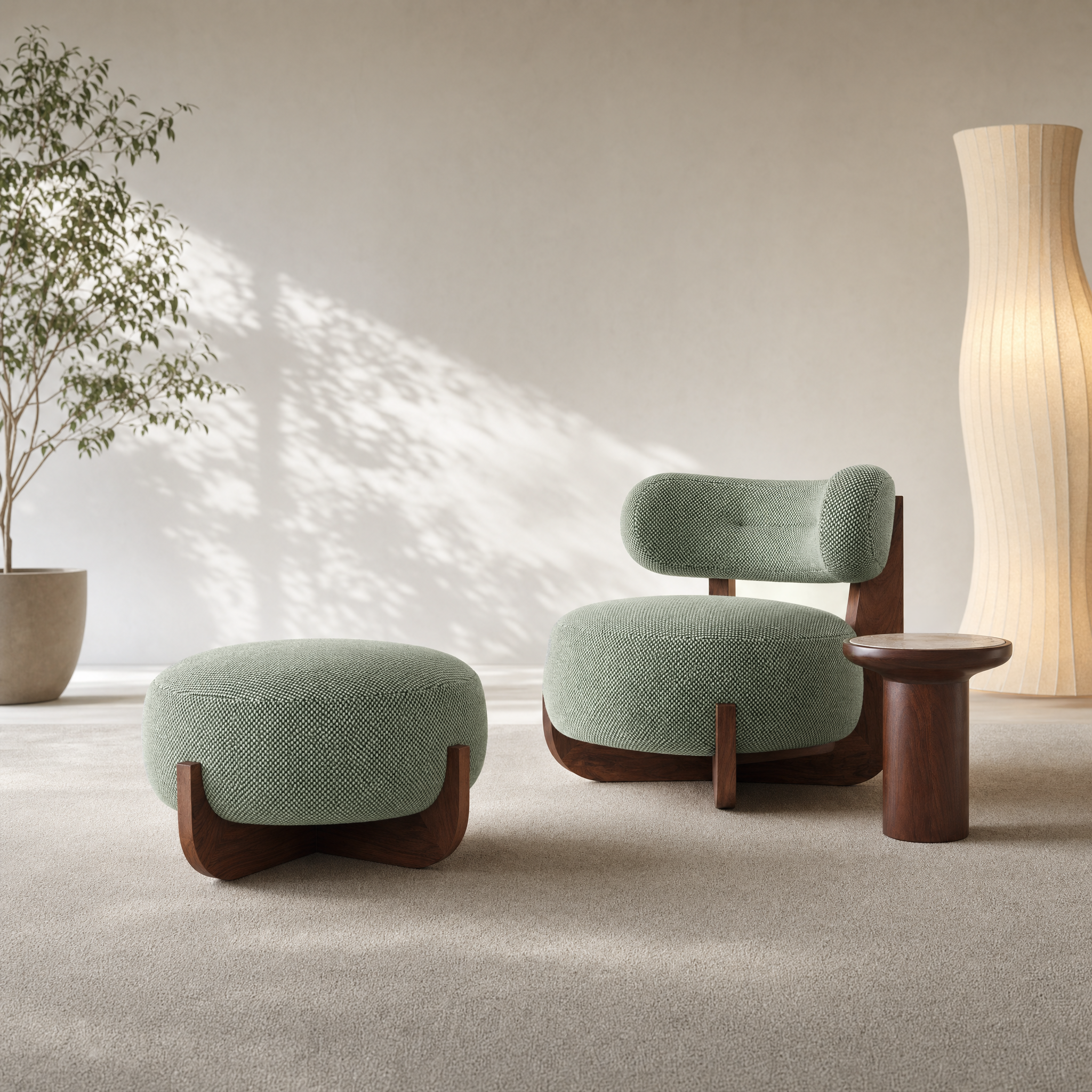 A modern lounge chair with a matching ottoman and a small side table in a minimalist room. The furniture features textured sage green upholstery and dark wood bases, set against a neutral beige wall with soft sunlight and a potted plant.
