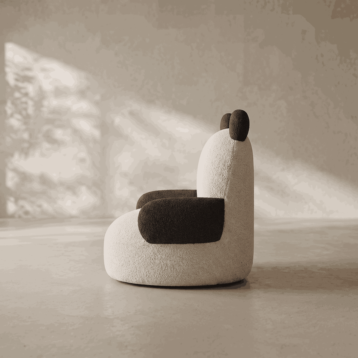 Side profile of a kids panda armchair in textured cream boucle fabric, showing its rounded silhouette with black plush ears, arm, and base.