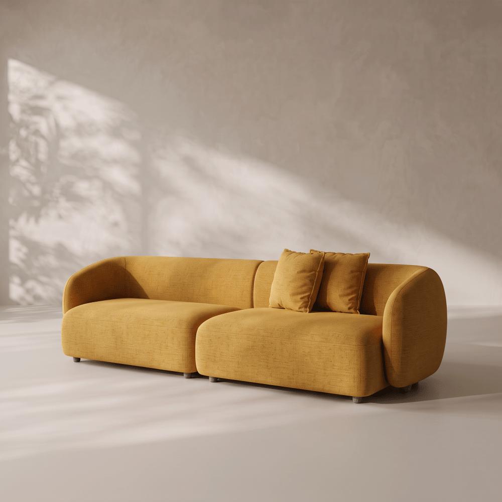 A modern modular yellow fabric sofa with two matching throw pillows, set in a minimalist room with textured walls and soft shadow patterns.