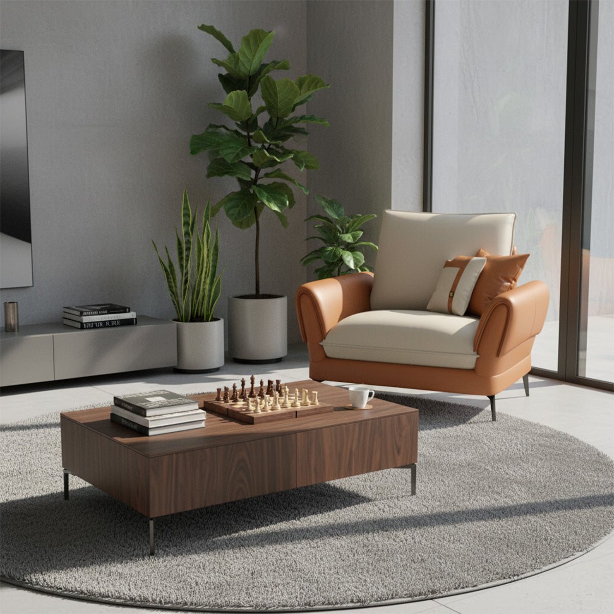 A single-seater NOVA armchair with tan leather arms and a cream seat cushion, positioned in a bright, modern living space. It sits on a round gray rug next to a dark wood square coffee table with a chess set on top. A large fiddle-leaf fig and snake plant are visible behind the chair against a gray wall.