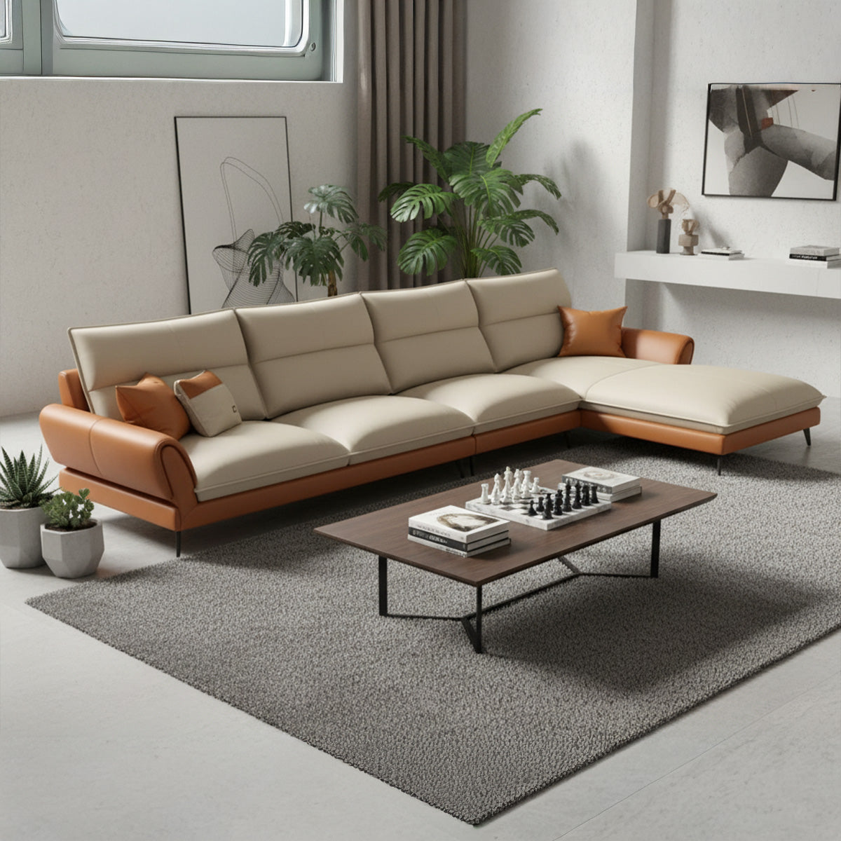 A spacious NOVA sectional sofa with a three-seater section and a left-hand facing chaise lounge (LHS). The upholstery is two-toned with tan leather trim and cream cushions. It is placed on a gray rug in a bright room with a white textured wall and potted plants. A dark wood coffee table with a chess set is in the foreground.