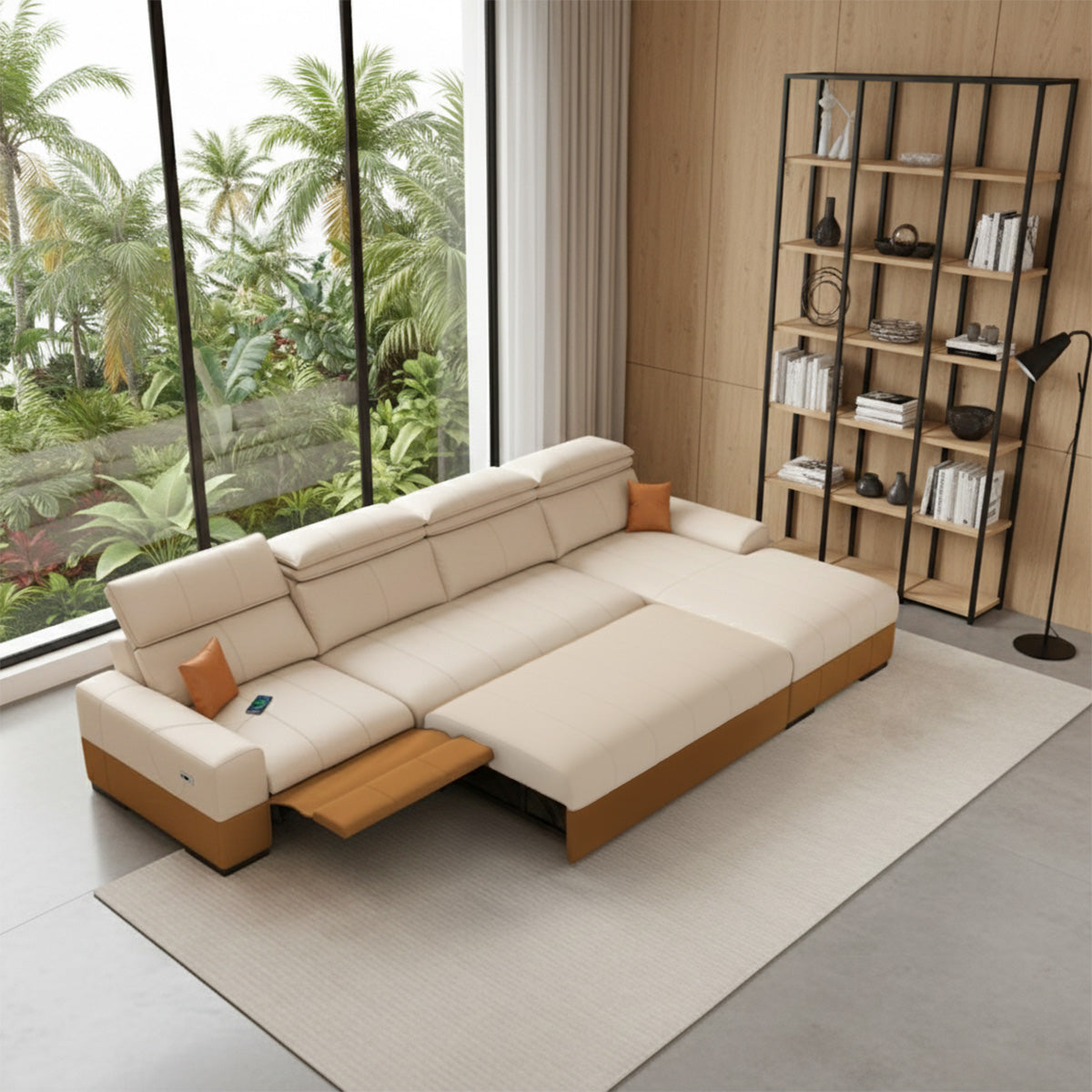 A wide-angle view of a long, two-toned cream and brown modular sofa with a chaise lounge end and an extended footrest, positioned by a large window overlooking a lush tropical garden and next to a tall black metal and wood bookshelf.