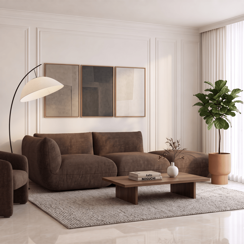 A modern living room scene featuring a brown velvet sectional sofa, a matching armchair, a wooden coffee table, a gray textured rug, a black floor lamp, and a potted fiddle-leaf fig plant against a cream paneled wall.