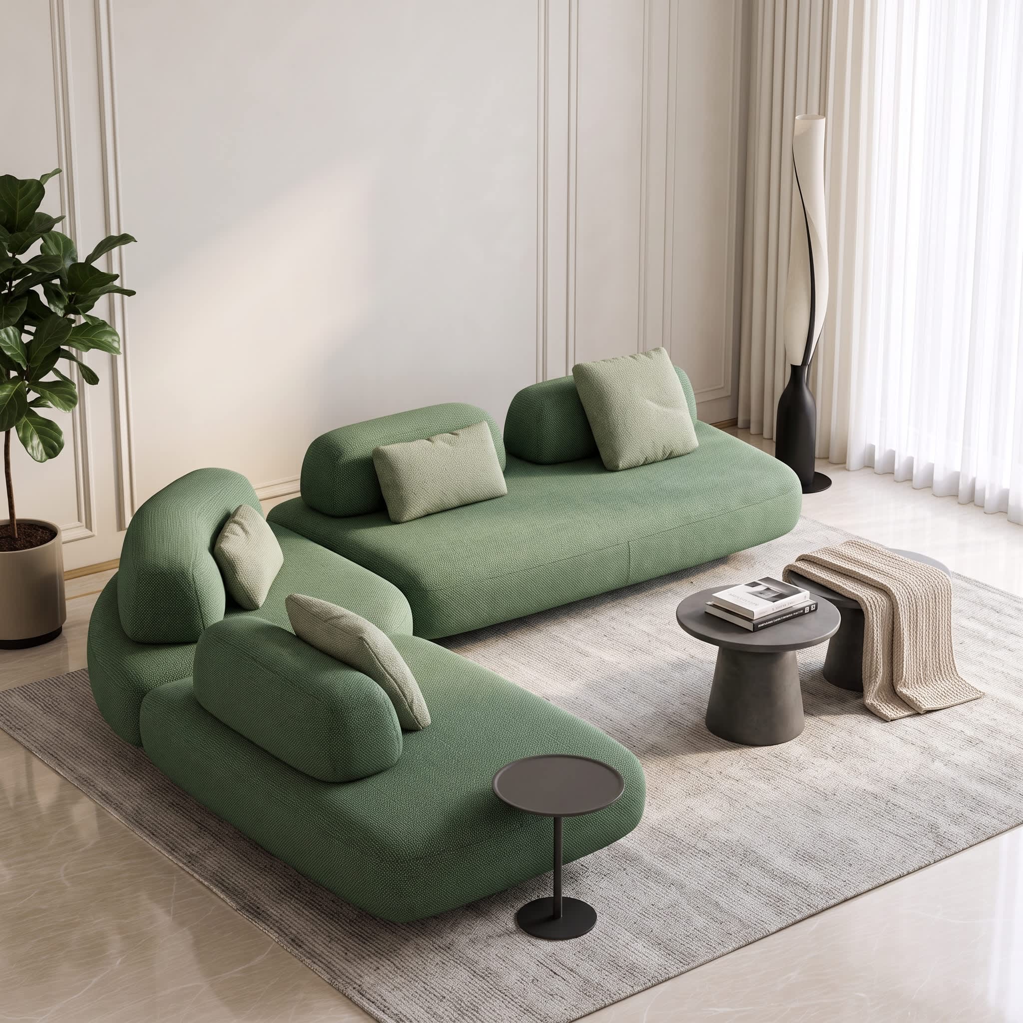 A modern modular sectional sofa in sage green fabric, styled in a bright, minimalist living room with a gray rug, small side tables, and a potted plant.