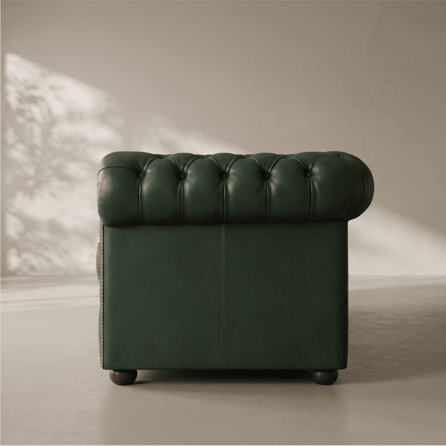A dark green tufted leather armchair shown from the back in a minimalist studio setting with soft shadow overlays.